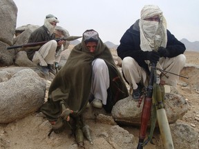 Taliban fighters pose with weapons in an undisclosed location in Afghanistan in this October 30, 2009 file photo. (REUTERS)