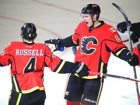 Calgary Flames Joe Colbourne cheers with Kris Russell after scoring the first for the Flames on Edmonton Oilers goalie Ben Scrivens in NHL hockey action at the Scotiabank Saddledome in Calgary, Alta. on Wednesday December 31, 2014. Mike Drew/Calgary Sun/QMI Agency