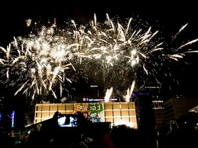 People take in the fireworks during New Year's Eve festivities in Sir Winston Churchill Square in Edmonton, Alta., on Wednesday, Dec. 31, 2014. Codie McLachlan/Edmonton Sun/QMI Agency