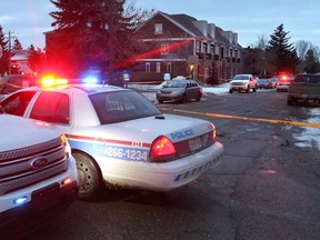 Crime scene tape and police vehicles at the scene of a New Year's Eve shooting that left as many as seven people injured in Calgary, Alta., on Thursday January 1, 2015. Mike Drew/ QMI Agency