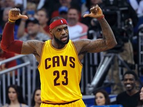 Cleveland Cavaliers forward LeBron James (23) points to his back of his jersey after he made a shot during the fourth quarter against the Orlando Magic at Amway Center. (Kim Klement-USA TODAY Sports)