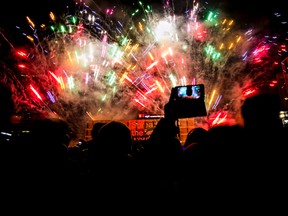 People take in the fireworks during New Year's Eve festivities in Sir Winston Churchill Square in Edmonton, Alta., on Wednesday, Dec. 31, 2014. Codie McLachlan/QMI Agency