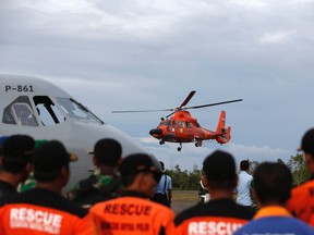 An Indonesian Search and Rescue helicopter takes off after delivering the remains of a passenger onboard the AirAsia QZ8501 flight, at the airport in Pangkalan Bun, Central Kalimantan January 1, 2015. Divers waiting to inspect the possible wreck of an AirAsia Indonesia jet off Borneo were unable to resume operations because of heavy seas on Thursday and an aviation official said it could take a week to find the black box flight recorders. REUTERS/Darren Whiteside