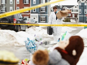 A technician prepares to work inside a home where seven members of a family were slain at 180A Avenue and 83 Street in Edmonton, Alta., on Thursday, Jan. 1, 2015. The slayings occurred on Dec. 29, 2014.  Sources say that 53-year-old Phu Lam is the killer; he later committed suicide inside a Fort Saskatchewan restaurant after killing eight members of his family. Ian Kucerak/Edmonton Sun/ QMI Agency