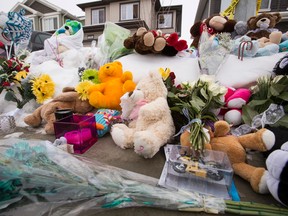 A memorial is seen for seven members of a family slain outside of their former home at 180A Avenue and 83 Street in Edmonton, Alta., on Thursday, Jan. 1, 2015. The slayings occurred on Dec. 29, 2014.  Sources say that 53-year-old Phu Lam is the killer; he later committed suicide inside a Fort Saskatchewan restaurant. Ian Kucerak/Edmonton Sun/ QMI Agency