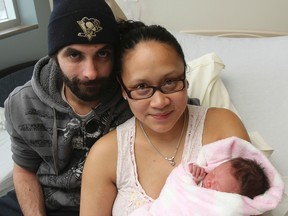 Kent Bedore, left and Djanen Esposo-Bedore welcome their daughter, Kaitlyn Allena Bedore, to the world on New Year's Day at Kingston General Hospital on Thursday. Kaitlyn was born at 2:38 a.m. (Julia McKay/The  Whig-Standard)