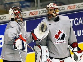Team Canada goalies Eric Comrie (left) and Zach Fucale chat during practice at the Air Canada Centre in Toronto, Jan. 1, 2015. (JACK BOLAND/QMI Agency)