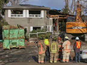 Firefighters stand outside a home on Camwood Ave. after a body was found inside there on Friday. (DAVE THOMAS/Toronto Sun)