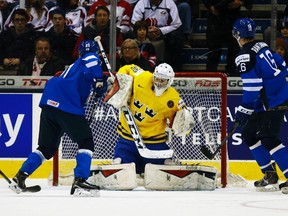 Finland's Aleski Mustonen (left) is stopped by Sweden goalie Linus Soderstrom during their World Junior Hockey Championship quarterfinal match at the Air Canada Centre in Toronto, Jan. 2, 2015. (JACK BOLAND/QMI Agency)