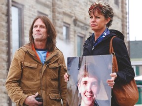 Willy and Kelly Stevenson, holding a life size photo of their late son Aaron, speak to the media outside the court house after a sentencing hearing for Rusty Pearce and Joseph Greer on Tuesday. DARCY CHEEK/QMI Agency