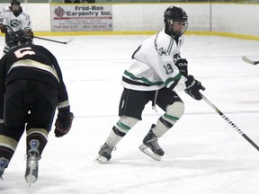 Brandon Jesson of the Lucan Irish stickhandles around East Lambton defenceman Jared Sanders during midget regional Silver Stick tournament play in Petrolia. Lucan was playing for the C championship Friday night against the Southwest Bullets. (TERRY BRIDGE, The Observer)