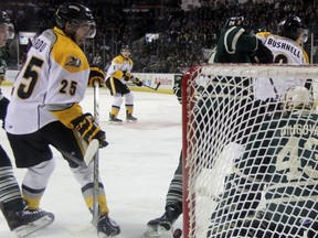 Sarnia Sting forward Jordan Kyrou eyes a loose puck in the London Knights' crease near goalie Michael Giugovaz. The Knights defeated Sarnia 8-6. (TERRY BRIDGE, The Observer)