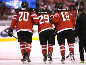Canada forward  Robby Fabbri (centre) is helped off the ice by teammates after he was injured during the team's World Junior Hockey Championship quarterfinal game against Denmark at the Air Canada Centre in Toronto, Jan. 2, 2015. (CRAIG ROBERTSON/QMI Agency)