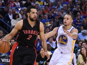 Landry Fields of the Raptors dribbles while being guarded by Steph Curry of the Golden State Warriors on Jan. 2. (USA Today Sports)