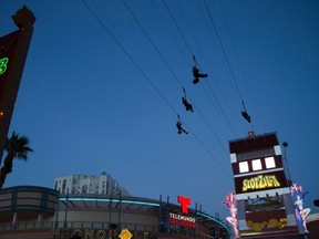 People try out the new 850-foot-long SlotZilla Zipline at the Fremont Street Experience in downtown Las Vegas, Nevada, April 30, 2014. REUTERS/ Steve Marcus