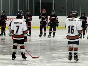 A moment of silence is observed during a game between North Seera and SWAT Rebels at Kennilworth Arena in Edmonton, Alta., on Saturday Jan.3, 2015. The tribute is for Cyndi Duong, a murder victim whose has children who play in the zone.  Perry Mah/Edmonton Sun/QMI Agency