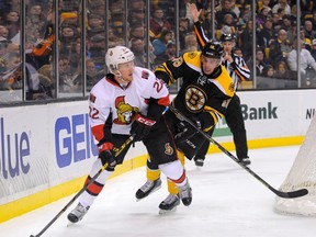 Jan 3, 2015; Boston, MA, USA; Boston Bruins right wing Reilly Smith (18) is called for a penalty on Ottawa Senators right wing Erik Condra (22) during the third period at TD Banknorth Garden. Mandatory Credit: Bob DeChiara-USA TODAY Sports
