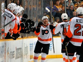 Claude Giroux #28 of the Philadelphia Flyers is congratulated by teammates after scoring a goal against the Nashville Predators during the second period of a game at Bridgestone Arena on December 27, 2014 in Nashville, Tennessee. (Frederick Breedon/Getty Images/AFP)