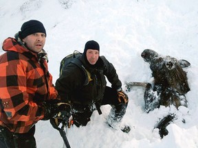 Robert Uphus, left, and Marty Mobley pose next to a moose they rescued. 
(Facebook photo)