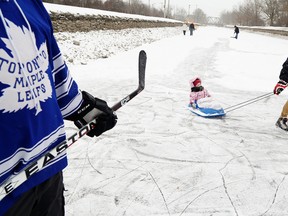 Justin Gutthardt, 14, pulls Grace, 18 months, on a sled next to Leafs fan Dave Morrison on the canal below the Peterborough Lift Lock on Saturday, Jan. 3, 2015. Clifford Skarstedt/Examiner