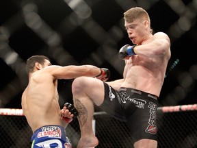 Paul Felder kicks at Danny Castillo in a lightweight bout during UFC 182 in the MGM Grand Garden Arena on January 3, 2015 in Las Vegas. (Steve Marcus/Getty Images/AFP)