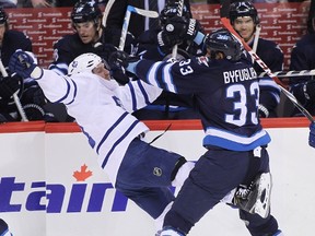 Dustin Byfuglien takes down the Leafs' David Clarkson on Saturday night. (MARIANNE HELM/Getty Images)