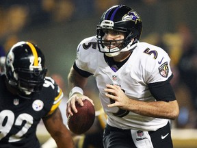 Baltimore Ravens quarterback Joe Flacco runs with the ball as Pittsburgh Steelers outside linebacker James Harrison gives chase during their AFC wild card playoff game at Heinz Field in Pittsburgh, Jan. 3, 2015. (USA Today)