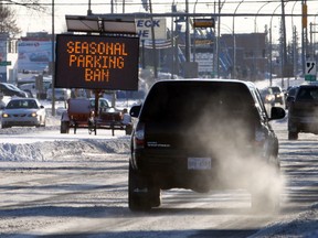 Motorists drive by a Parking Ban notice at 50 Street and 91 Avenue on Saturday. The parking ban started at 11 p.m. Saturday. (Perry Mah/Edmonton Sun)
