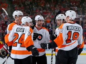 Vincent Lecavalier #40 of the Philadelphia Flyers is congratulated by teammates Matt Read #24,Andrew MacDonald #47,Michael Del Zotto #15 and R.J. Umberger #18 after Lecavalier scored a goal in the third period against the New Jersey Devils on January 3, 2015 at the Prudential Center in Newark, New Jersey. (Elsa/Getty Images/AFP)