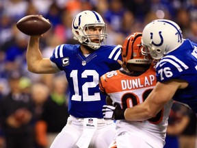 Indianapolis Colts quarterback Andrew Luck (12) throws a pass against the Cincinnati Bengals in the first quarter in the 2014 AFC Wild Card playoff football game at Lucas Oil Stadium. (Andrew Weber-USA TODAY Sports)