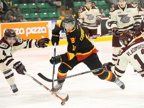Belleville Bulls forward Michael Cramarossa splits the Peterborough Petes D during OHL action Saturday night at Yardmen Arena. (Don Carr for The Intelligencer)