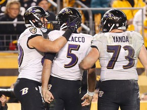 Baltimore Ravens tight end Crockett Gillmore (80) celebrates with Ravens quarterback Joe Flacco (5) and Ravens guard Marshal Yanda (73) after scoring a touchdown against the Pittsburgh Steelers in the fourth quarter during the 2014 AFC Wild Card playoff football game at Heinz Field. (Geoff Burke-USA TODAY Sports)