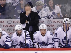 Maple Leafs head coach Randy Carlyle can't bear to watch during a 5-1 loss to the Jets in Winnipeg on Saturday night. (Getty Images/AFP)