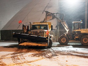 City of Kingston plows were having their salt and sand dumps filled into the evening Saturday, this one at the 141 Railway St., location.  (Steph Crosier/The Whig-Standard)