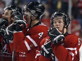 Canada's Ryan Ellis (R), Dylan Olsen (C) and Brayden Schenn (L) react after losing to Russia in the gold medal game at the IIHF World Junior Hockey Championships in Buffalo, New York, January 5, 2011.          (REUTERS/Mark Blinch)