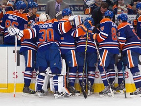 The Edmonton Oilers gather at their bench during a third period timeout during their game against the New York Islanders at Rexall Place, in Edmonton Alta., on Sunday Jan. 4, 2015. The Oilers won 5-2. David Bloom/Edmonton Sun/QMI Agency
