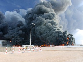 Smoke rises from an oil tank fire in Es Sider port December 26, 2014. A fire at an oil storage tank at Libya's Es Sider port has spread to two more tanks after a rocket hit the country's biggest terminal during clashes between forces allied to competing governments, officials said on Friday. (REUTERS/Stringer)