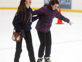 Kyra Allen and her friend Emily Thornburrow enjoy a laugh as they take part in public skating at the Wallaceburg Memorial Arena on Jan. 2.