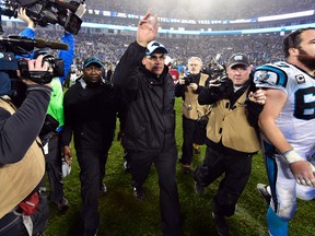 Panthers head coach Ron Rivera runs off the field after beating the Cardinals in the NFC Wild Card game at Bank of America Stadium in Charlotte, N.C., on Saturday, Jan. 3, 2015. (Bob Donnan/USA TODAY Sports)