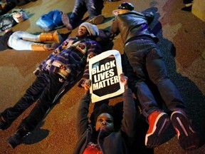 Protesters stage a "die-in" as part of a protest over the shooting death of Michael Brown, in Webster Grove, Missouri, December 2, 2014. Police officer Darren Wilson fatally shot Brown during an August 9 confrontation in Ferguson, Missouri, about 12 miles outside St. Louis, which set off a national debate on race and policing.  (REUTERS/Jim Young)