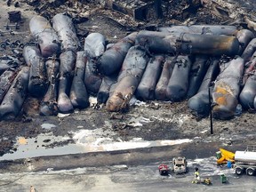 A firefighter stands close to the remains of a train wreckage in Lac Megantic in this file photo taken July 8, 2013. (REUTERS/Mathieu Belanger/Files)