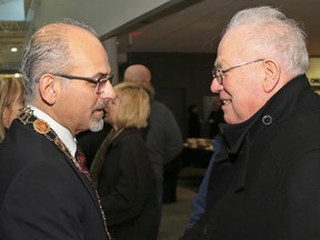 Luke Hendry/The Intelligencer
Belleville Mayor Taso Christopher, left, greets Quinte West Mayor Jim Harrison at Christopher's New Year's levee at the Quinte Sports and Wellness Centre in Belleville Thursday, Jan. 1, 2015. They and Prince Edward County Mayor will each meet separately with Quinte Health Care's chief executive officer and chairman Tuesday.