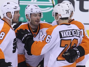Philadelphia Flyers defenceman Mark Streit (32) is congratulated  by Nicklas Grossman, Chris VandeVelde and Pierre-Edouard Bellemare (from left) during an NHL game in December, 2014. Kevin King/Winnipeg Sun/QMI Agency