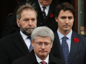 Prime Minister Stephen Harper (front), Leader of the Opposition Thomas Mulcair (top L) and Liberal leader Justin Trudeau leave the church following the funeral of Warrant Officer Patrice Vincent, in Longueuil, Quebec November 1, 2014.  REUTERS/Chris Wattie