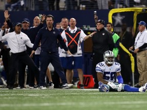 Anthony Hitchens of the Dallas Cowboys sits on the turf after a flag was thrown as he defended Brandon Pettigrew of the Detroit Lions on a pass play during the second half of their NFC Wild Card Playoff game at AT&T Stadium on January 4, 2015. (Sarah Glenn/Getty Images/AFP)