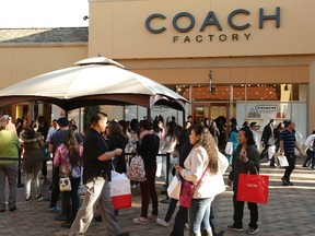 People wait in line to enter a Coach Factory outlet store during day after Christmas sales at Citadel Outlets in Los Angeles, California December 26, 2014. REUTERS/Jonathan Alcorn