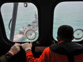 A Malaysian Navy ship is seen from an Indonesian Air Force Super Puma helicopter during a search mission for for AirAsia flight QZ8501 off the coast of Central Kalimantan January 6, 2015. REUTERS/Veri Sanovri/Pool