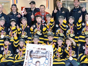 The Sarnia Sting minor novice MD hockey team met Walter Gretzky after winning the 45th annual Wayne Gretzky tournament in Brantford. Back row from left are manager Bryan Shaw, trainer Dave Knight, assistant coach Chris Nesbitt, Walter Gretzky, head coach Mike Van Sickle and assistant coach Derek Kominek. Middle row from left are Ryder Haynes, Alex Patrinos, Kaia Pierce, Carson Crawford, Jack Nesbitt, Owen Knight, Colin Bracewell and Evan Van Sickle. Front row from left are Rowan Fisher, James Guthrie, Carter Whitworth, Nate Shaw, Connor Kominek, Carter Fogarty and Cohnlan Lucas. Absent is Weston Gower. (SUBMITTED PHOTO)