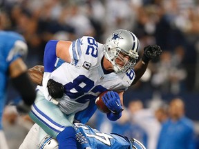 Cowboys tight end Jason Witten (82) is hit after a catch by Lions strong safety James Ihedigbo (32) and Isa Abdul-Quddus (42) during the NFC Wild Card playoff game in Arlington, Texas, on Sunday, Jan. 4, 2015. (Matthew Emmons/USA TODAY Sports)