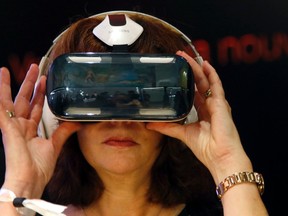An attendee tries an Oculus-powered Samsung Gear VR headset during the French telecom Orange annual company's innovations show in Paris Oct. 2, 2014.  REUTERS FILE PHOTO/Charles Platiau